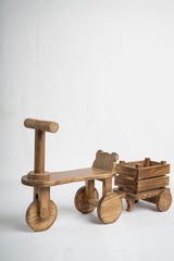 Wooden tricycle baby photoshoot prop with attached crate wagon for newborn and toddler photography.
